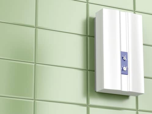water heater attached to green tiled wall